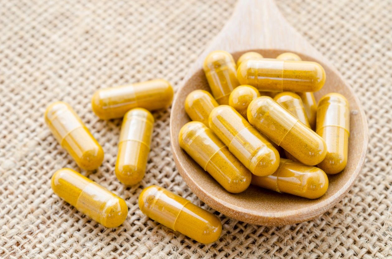 A set of golden vitamins in a small bowl